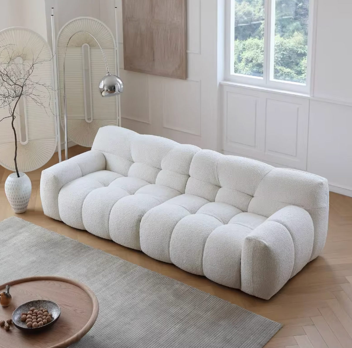 Cora Cloud Two / Three Seater Sofa, Boucle, side view of oblong wood dining table